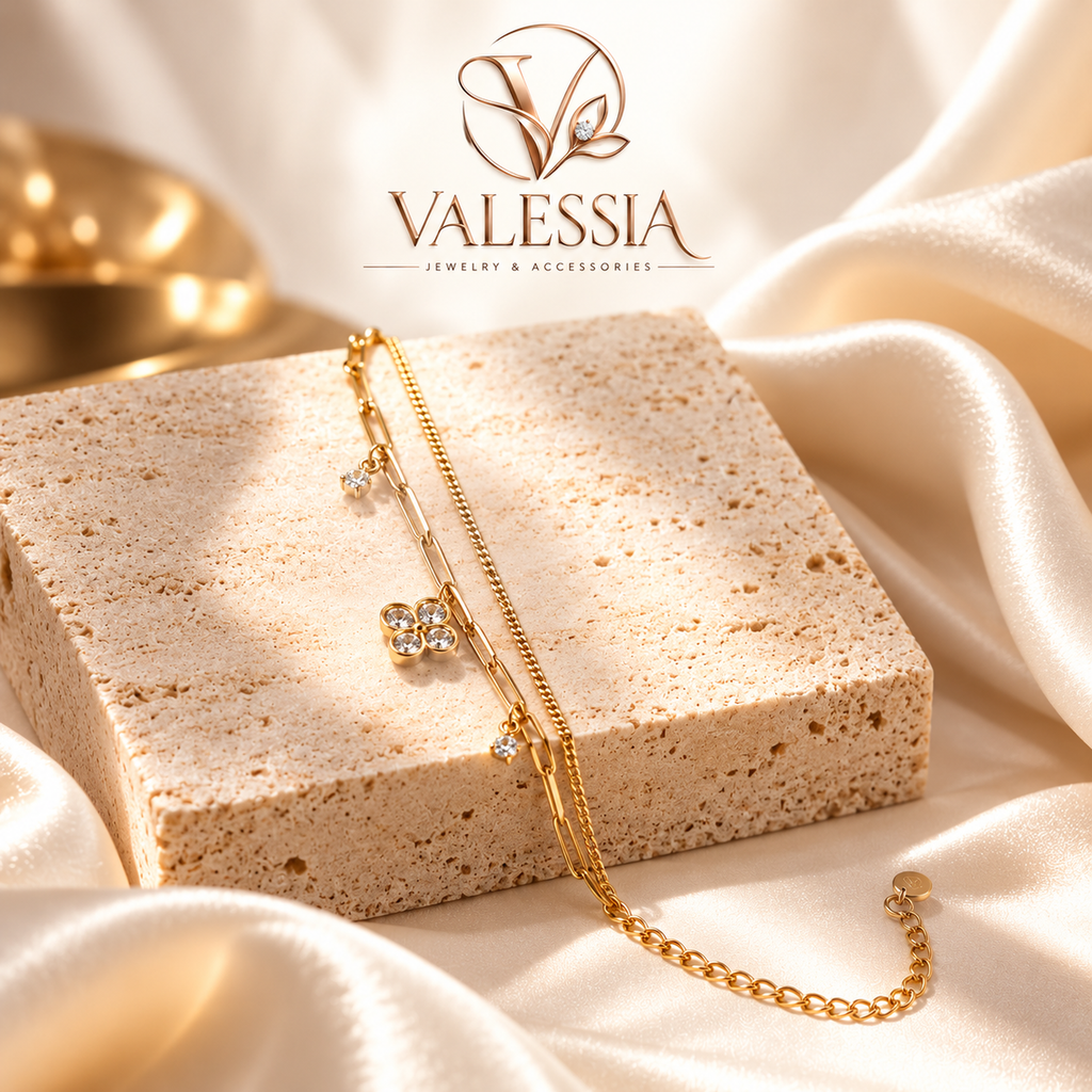 Gold and silver-tone double-chain bracelet with a four-leaf clover charm